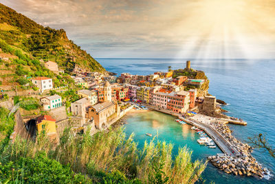 High angle view of townscape by sea against sky