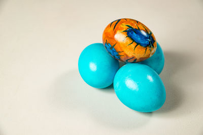 High angle view of multi colored eggs on white background