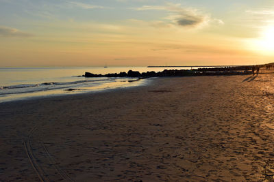 Scenic view of beach against sky during sunset