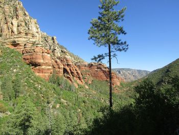 Scenic view of mountains against clear blue sky