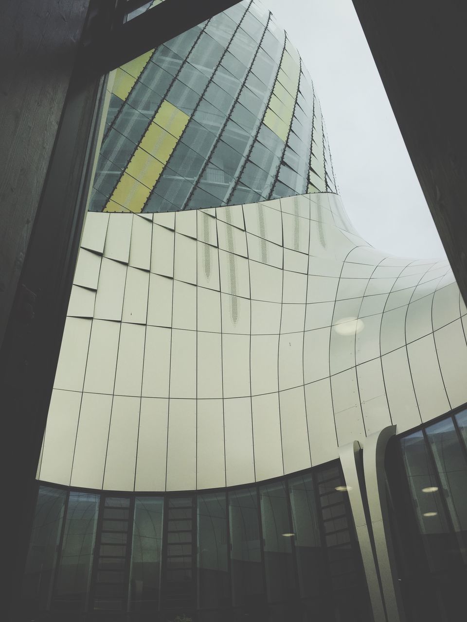 indoors, low angle view, glass - material, ceiling, architecture, built structure, repetition, modern, day, glass, office building, architectural feature, no people, architectural design