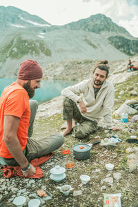 People enjoying on mountain against mountains
