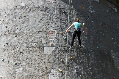 High angle view of man climbing on rock