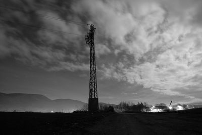 Low angle view of windmill on field against sky