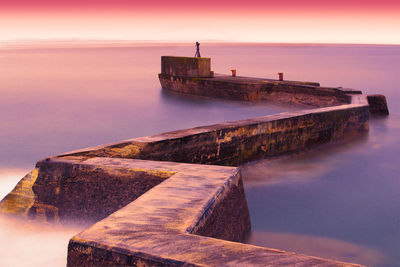 Scenic view of sea against sky at sunset