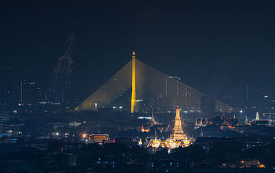 Illuminated modern buildings in city at night