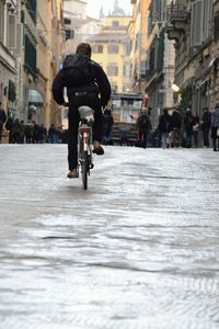 Man riding bicycle on city street