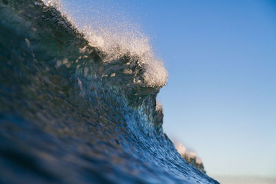 Close-up of sea against clear blue sky