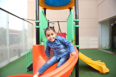 Portrait of happy girl playing at playground