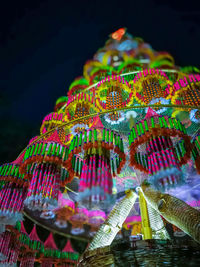 Low angle view of illuminated lights against sky at night