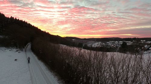 Panoramic view of agricultural landscape against sky during sunset