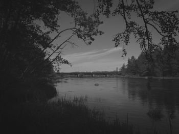 Scenic view of lake against sky at dusk