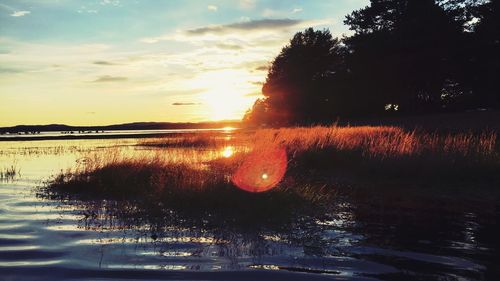Scenic view of lake against sky during sunset