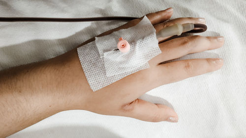 High angle view of woman lying on hand
