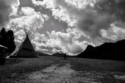 View of tent on field against cloudy sky