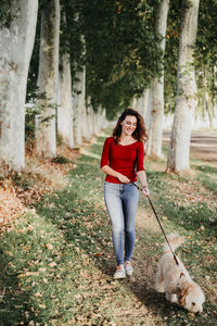 Portrait of a smiling young woman with dog