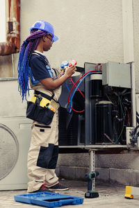 Rear view of man standing in factory