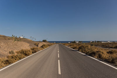 Empty road towards the sea in fuerteventura, canary islands