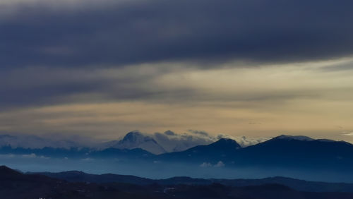 Scenic view of silhouette mountains against sky during sunset