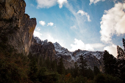 Low angle view of rocky mountains against sky