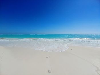 Scenic view of sea against clear blue sky