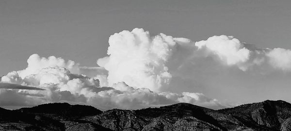 Low angle view of smoke emitting from mountain against sky