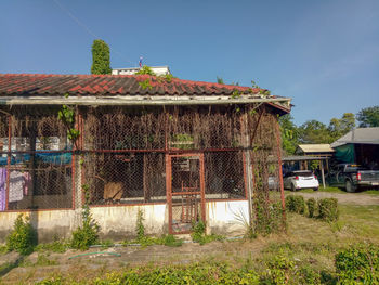 Exterior of old house on field against sky