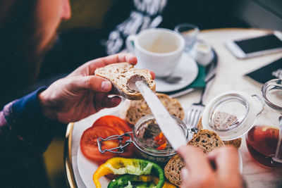 High angle view of man eating food on table