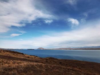 Scenic view of landscape against cloudy sky