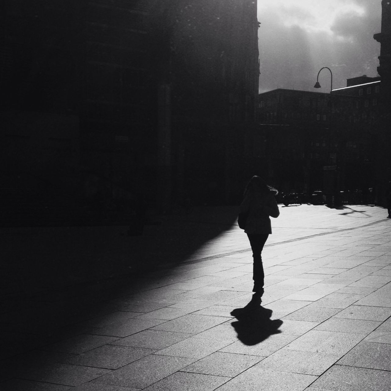 full length, lifestyles, architecture, building exterior, built structure, walking, leisure activity, street, standing, rear view, casual clothing, men, city, shadow, person, city life, sidewalk, day