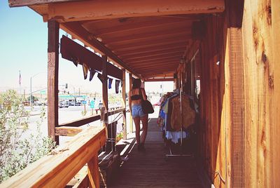 Full length of woman standing on railing
