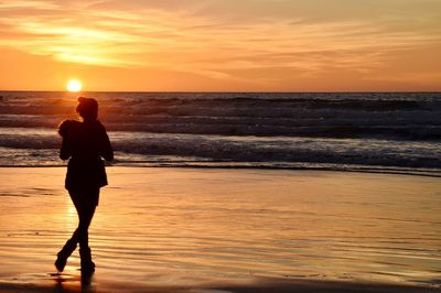 Rear view of man standing on beach