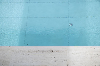 Close-up of blue wall by swimming pool