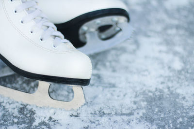 Figure skates on an ice background. ice skating outdoor activities with the family in winter.
