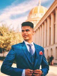 Smiling young businessman standing outdoors