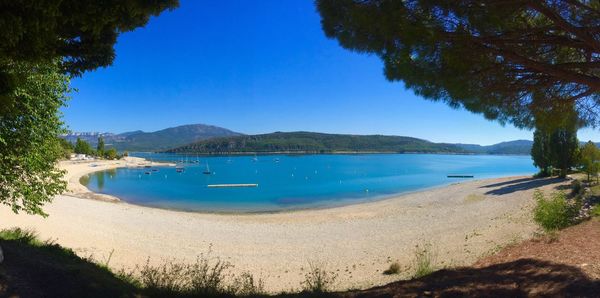 Scenic view of sea against clear blue sky