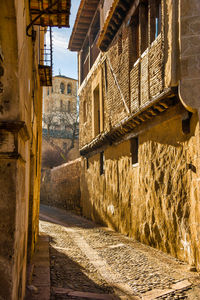 Narrow alley amidst buildings in city