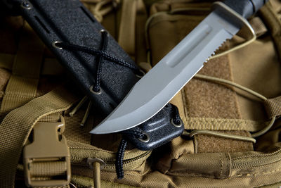 High angle view of knife on backpack