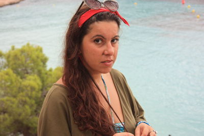 Portrait of beautiful woman against sea