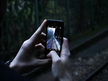 Close-up of woman using mobile phone in forest