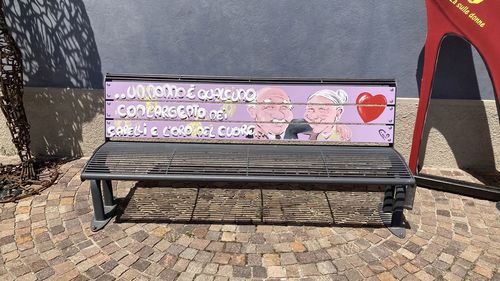 Graffiti on bench against wall