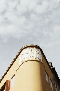 Low angle view of building against cloudy sky