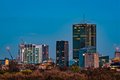 Modern cityscape against clear blue sky