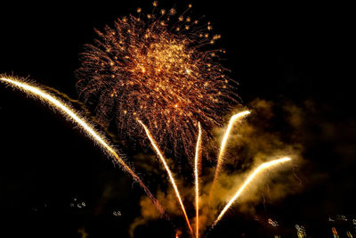 Low angle view of firework display at night