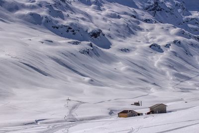 Scenic view of snow covered mountain against cloudy sky