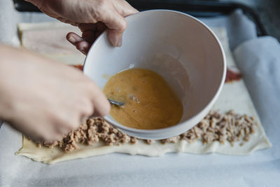 Crop person mixing egg for pastry person