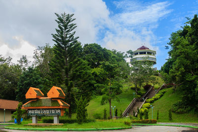 Built structure by trees against sky