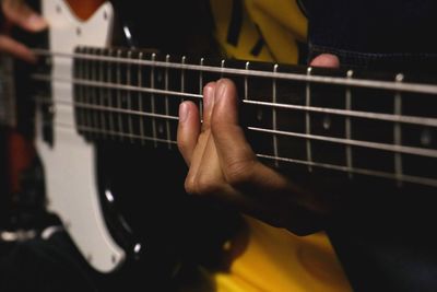 Close-up of man playing guitar