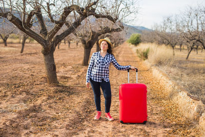 Portrait of woman standing against plants