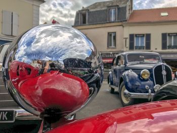 Close-up of red vintage car on building